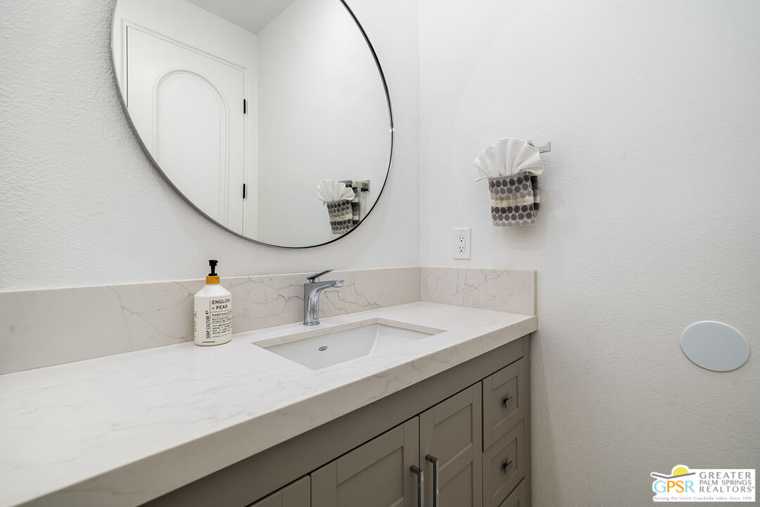 74226 Via Venezia Palm Desert, CA 92260 - Photo 28 of 38 a bathroom with a sink and a mirror