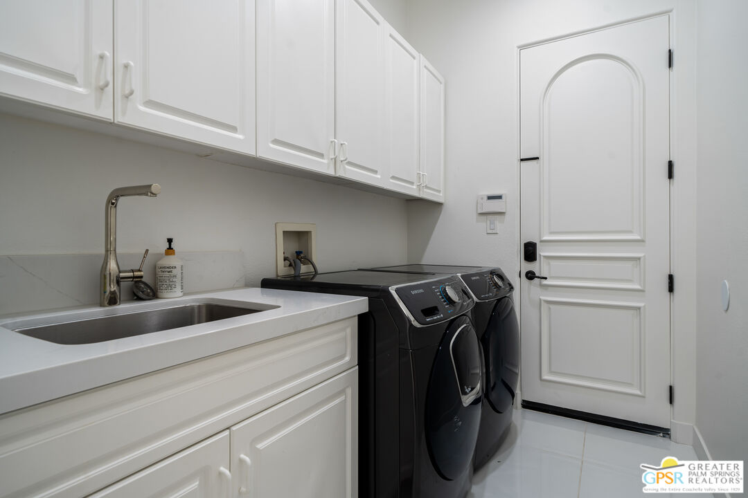74226 Via Venezia Palm Desert, CA 92260 - Photo 33 of 38 a utility room with dryer and washer