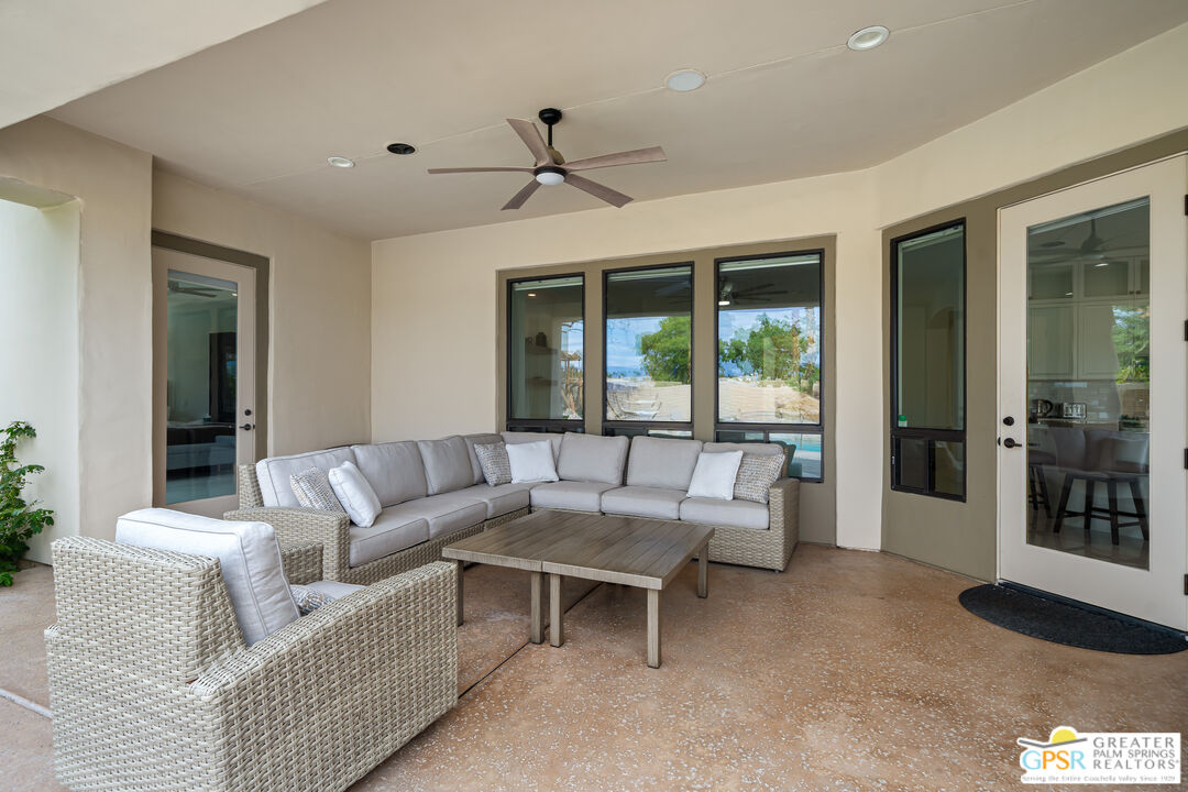 74226 Via Venezia Palm Desert, CA 92260 - Photo 35 of 38 a living room with furniture and a large window