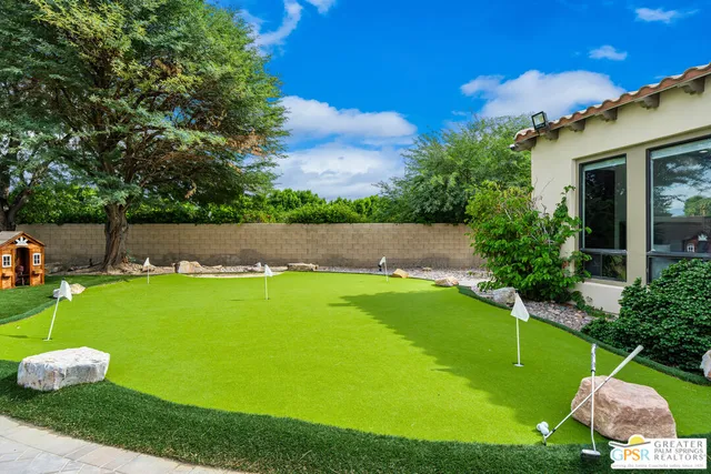 an aerial view of a house with a yard and trees
