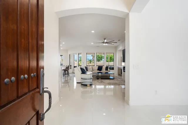 a living room with furniture and large window