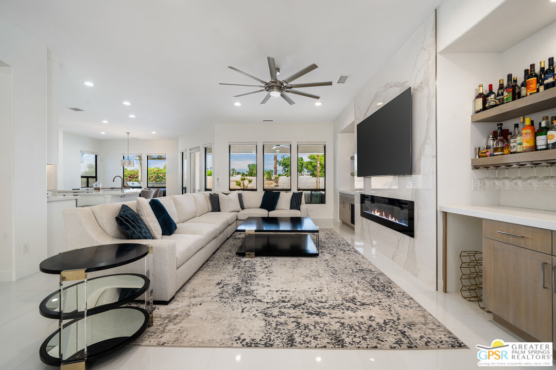 74226 Via Venezia Palm Desert, CA 92260 - Photo 7 of 38 a living room with furniture and a flat screen tv