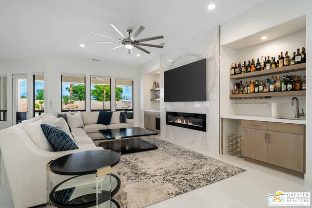 a living room with furniture a fireplace and a flat screen tv