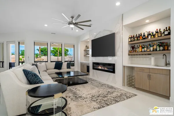 a living room with furniture a fireplace and a flat screen tv