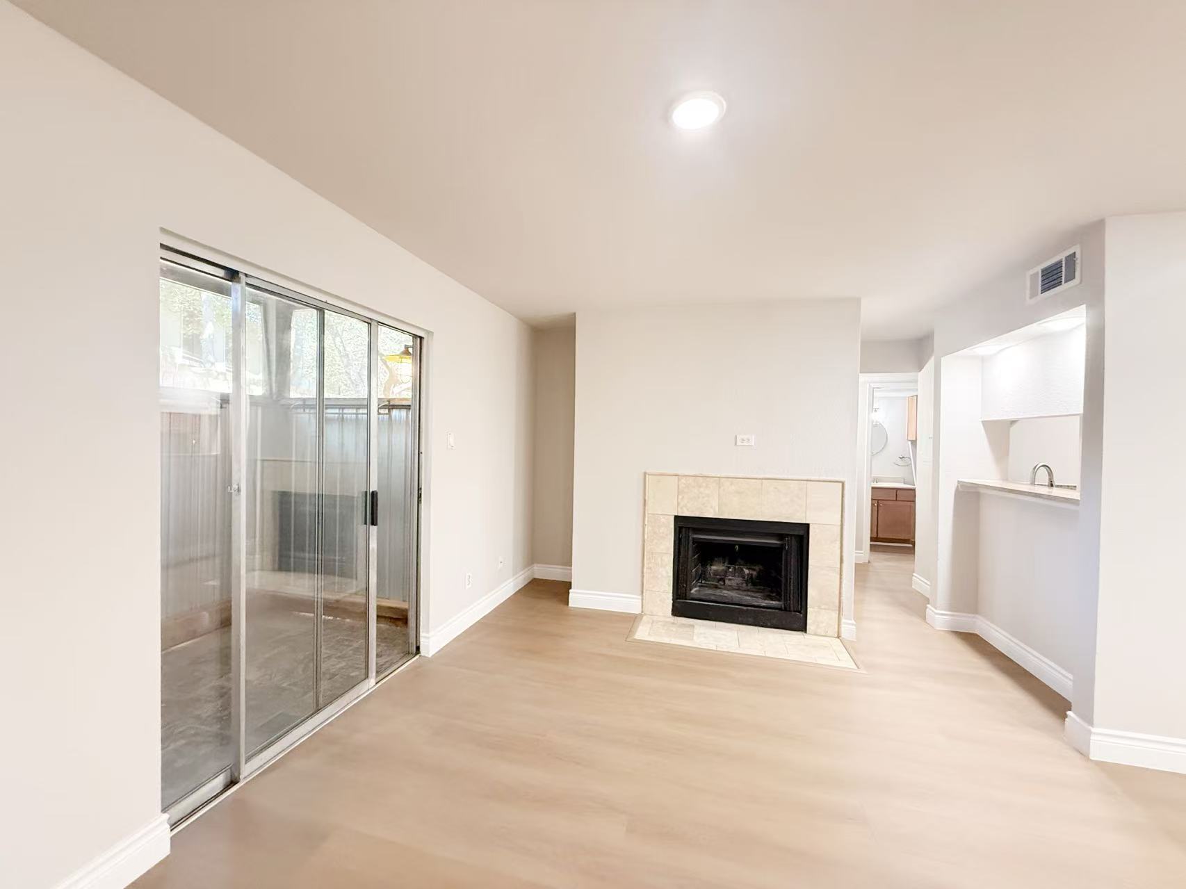 3204 Menchaca Road, Unit 601 Austin, TX 78704 - Photo 2 of 12 a view of an empty room with a fireplace and a window