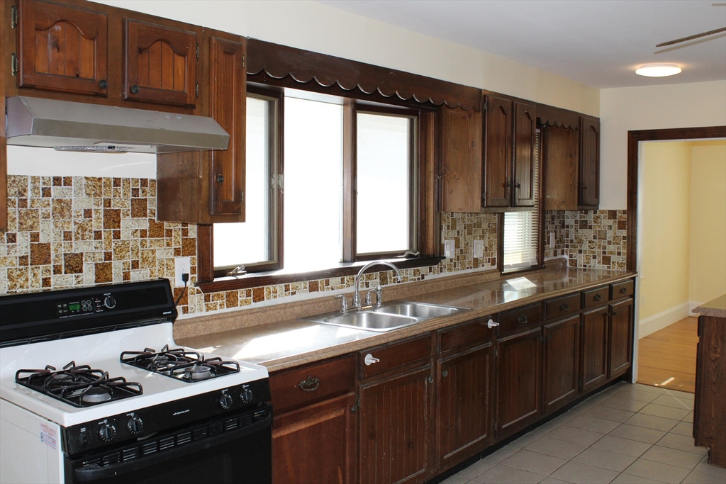 242 Newbury Avenue, Unit 2 Quincy, MA 02171 - Photo 2 of 6 a kitchen with stainless steel appliances sink cabinets and window