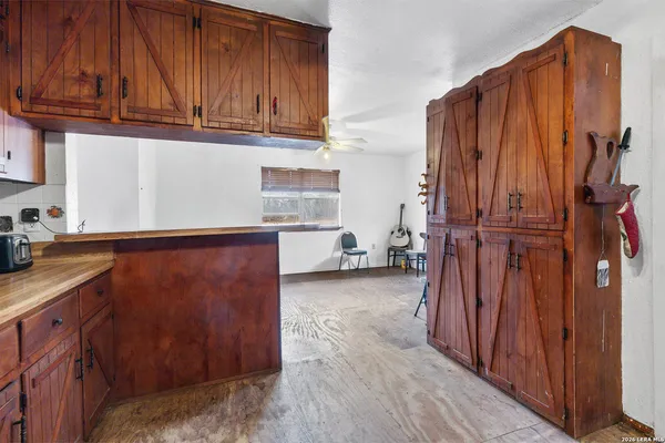 a kitchen with stainless steel appliances granite countertop a refrigerator and wooden cabinets