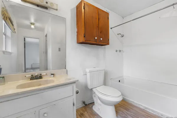 a bathroom with a sink a toilet and bathtub