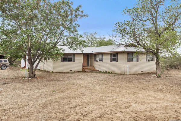 a view of a house with a tree in the background
