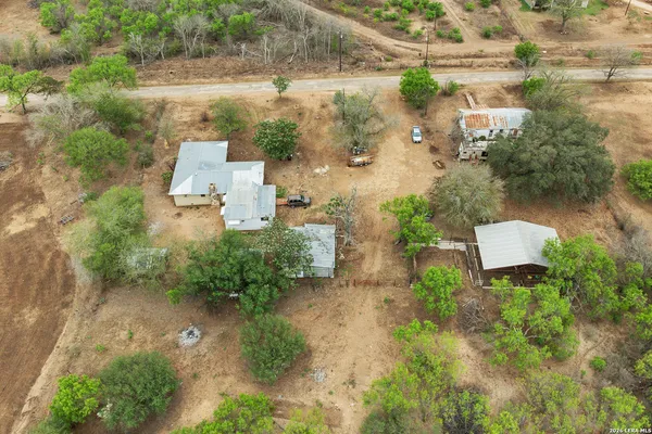 an aerial view of a house with a yard