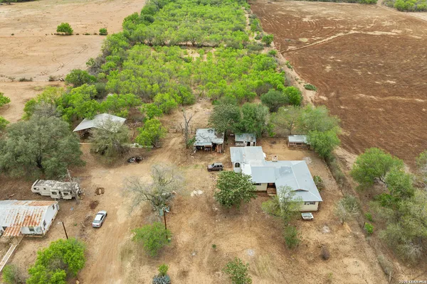 an aerial view of a house with a yard