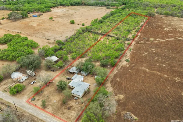 an aerial view of a house with a yard
