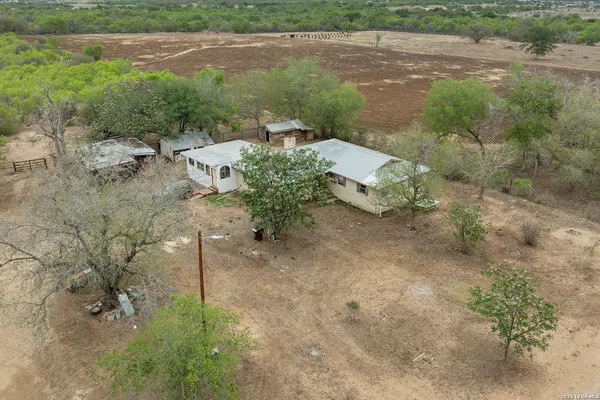 an aerial view of a house with a yard