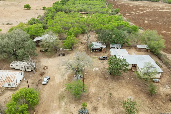 an aerial view of a house with a yard