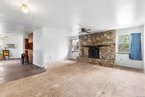 an empty room with furniture and a fireplace