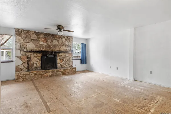 a view of empty room with a fireplace