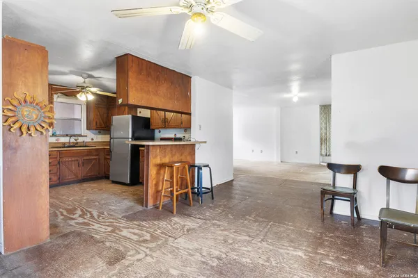 a view of kitchen with furniture and a refrigerator