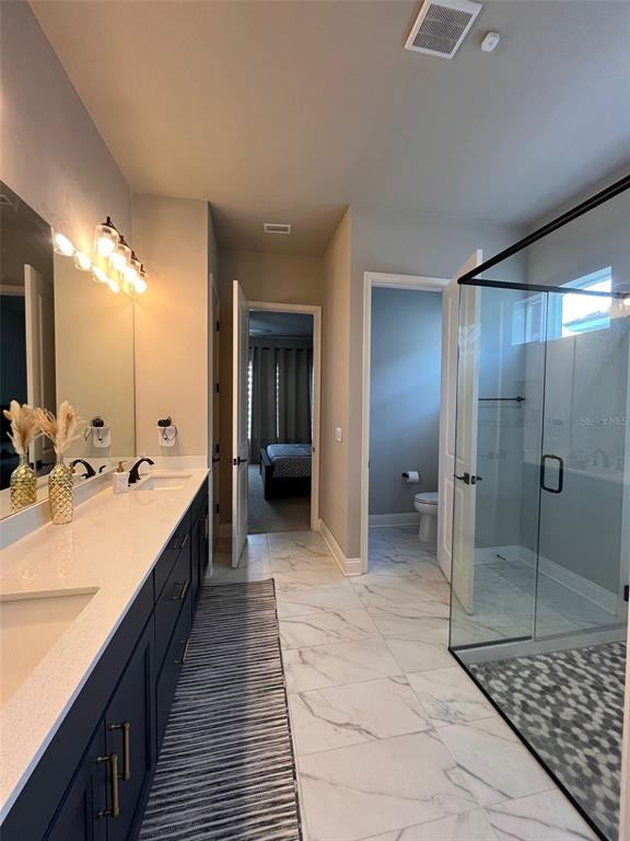 12149 Southwest 33rd Place Gainesville, FL 32608 - Photo 14 of 35 a large bathroom with a glass door shower