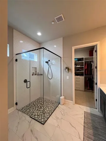 a bathroom with a shower and a sink
