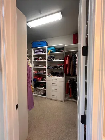 a view of walk in closet with clothes