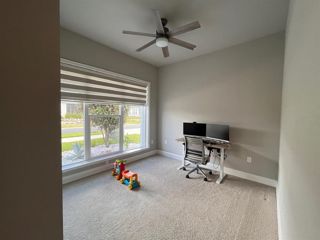12149 Southwest 33rd Place Gainesville, FL 32608 - Photo 22 of 35 a view of a workspace with furniture and a window
