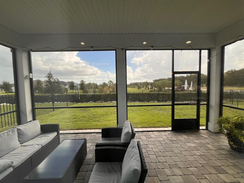 12149 Southwest 33rd Place Gainesville, FL 32608 - Photo 31 of 35 a living room with furniture and floor to ceiling windows
