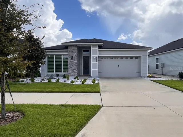 a front view of house with a garden