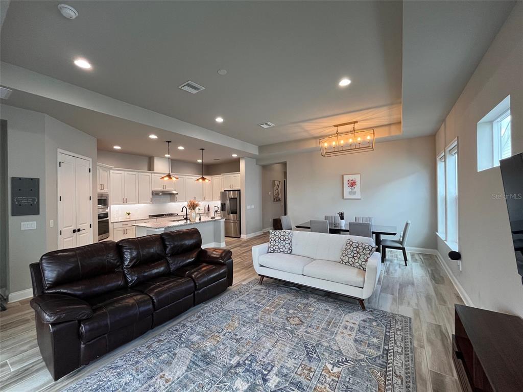 12149 Southwest 33rd Place Gainesville, FL 32608 - Photo 6 of 35 a living room with furniture and a flat screen tv