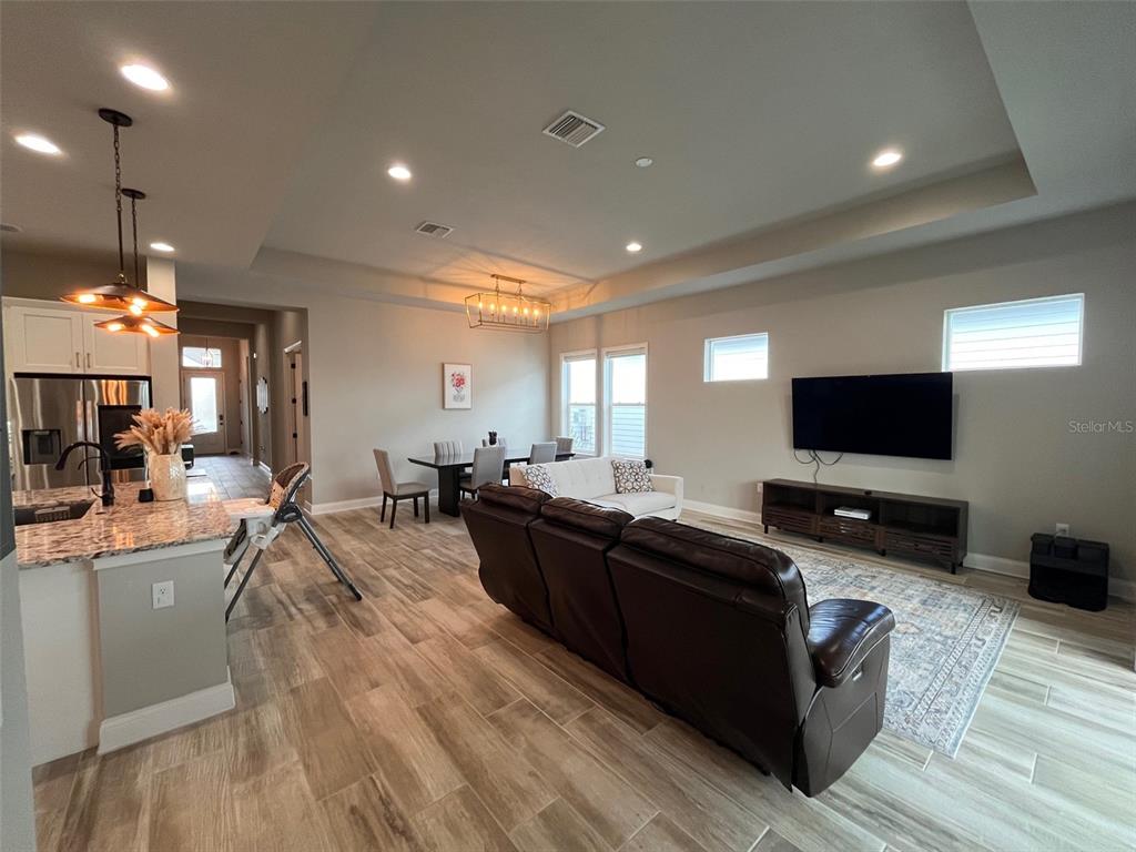 12149 Southwest 33rd Place Gainesville, FL 32608 - Photo 10 of 35 a living room with furniture and a flat screen tv