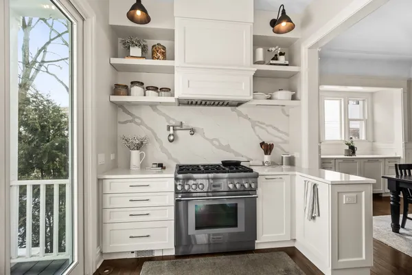 a kitchen with a table chairs and wooden cabinets