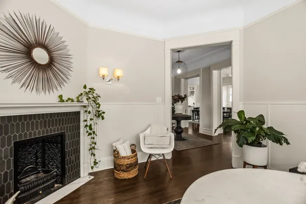 a view of a hallway with wooden floor and dining room