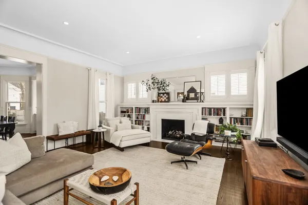 a living room with furniture flat screen tv and wooden floor