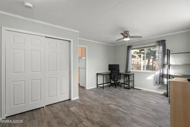 a view of a workspace with furniture and a window