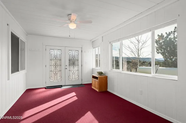 a livingroom with window and outdoor space