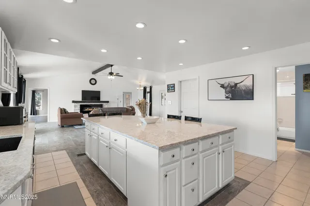 a large kitchen with stainless steel appliances granite countertop a large counter top and a stove