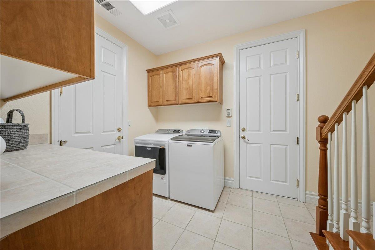 9133 Cedar Ridge Drive Granite Bay, CA 95746 - Photo 23 of 55 Spacious laundry room with access to both garages and back staircase.