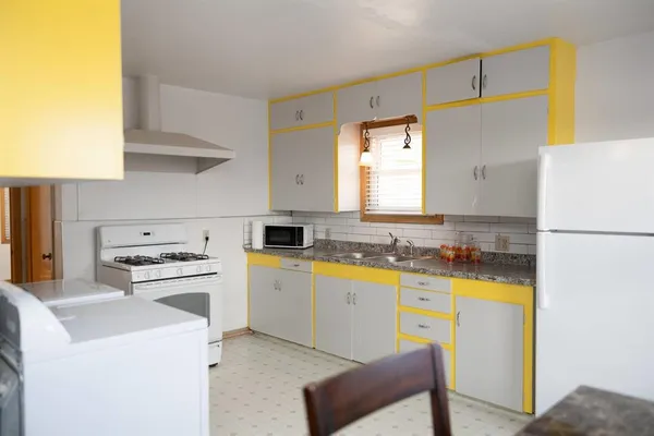a kitchen with a sink a stove and refrigerator