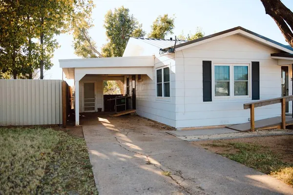 a view of a house with a yard and porch