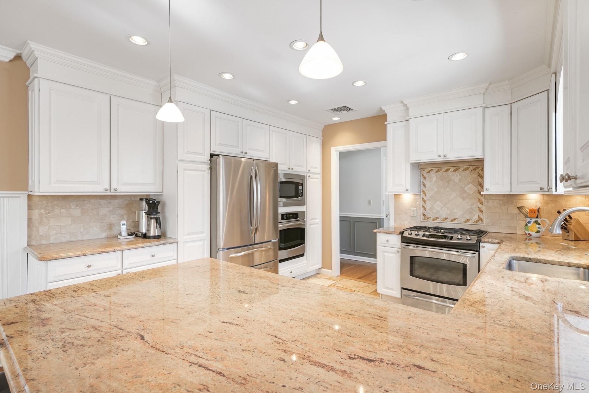 100 Yale Road Hartsdale, NY 10530 - Photo 16 of 42 a kitchen with stainless steel appliances granite countertop a stove a refrigerator and a sink with granite countertops
