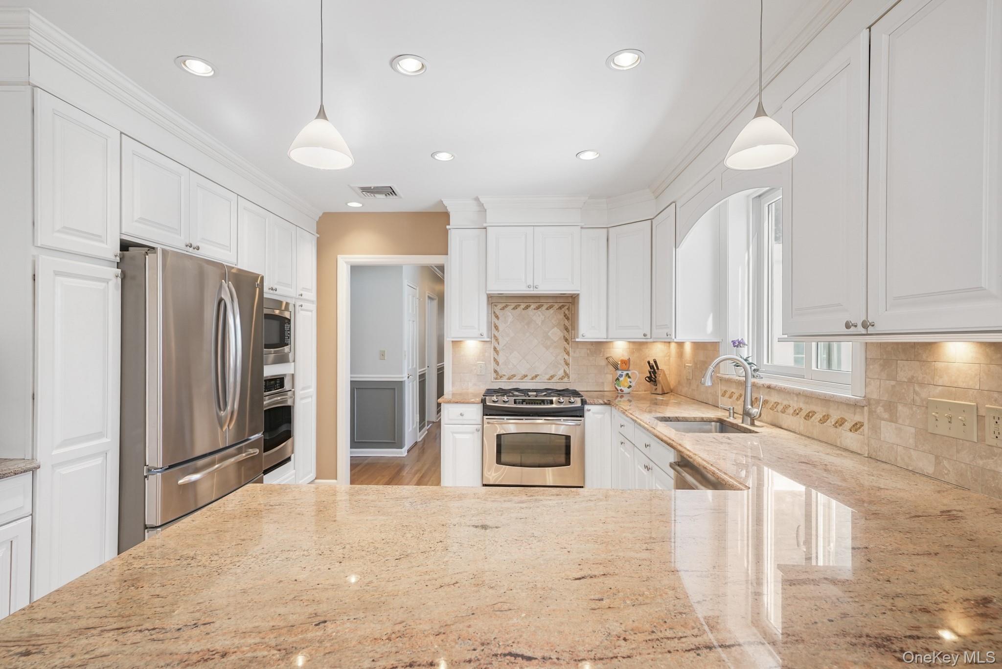 100 Yale Road Hartsdale, NY 10530 - Photo 17 of 42 a kitchen with stainless steel appliances granite countertop a refrigerator a stove a sink and a refrigerator