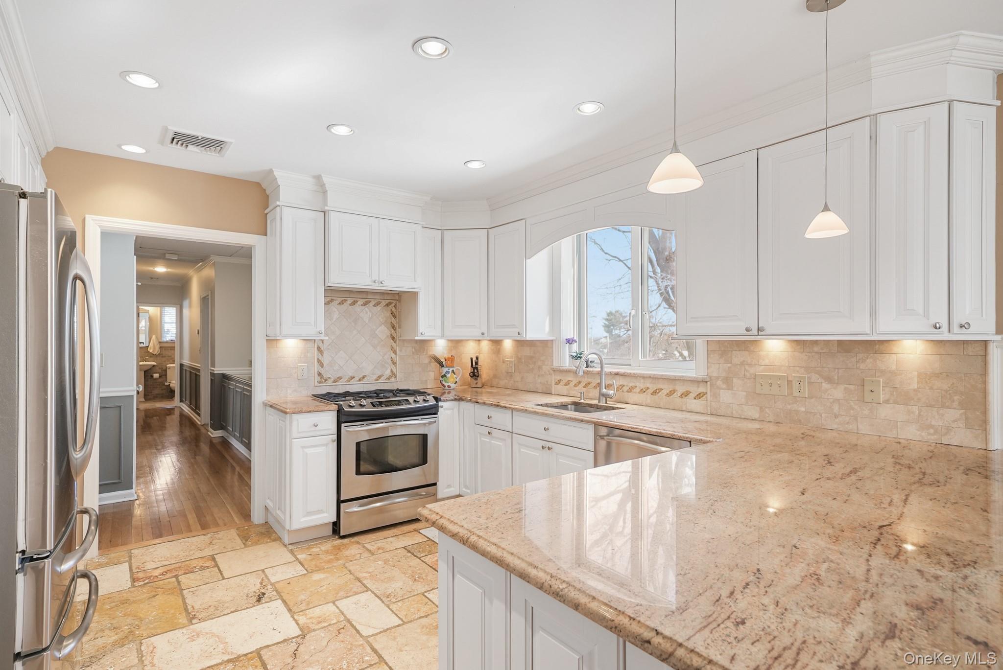 100 Yale Road Hartsdale, NY 10530 - Photo 18 of 42 a kitchen with kitchen island granite countertop a stove a sink and a refrigerator