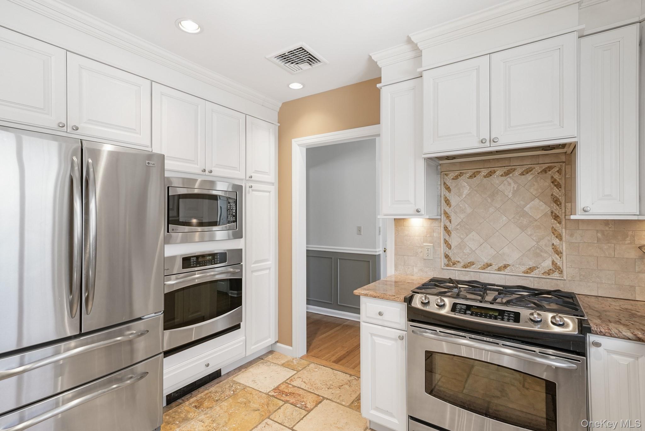 100 Yale Road Hartsdale, NY 10530 - Photo 19 of 42 a kitchen with stainless steel appliances and white cabinets