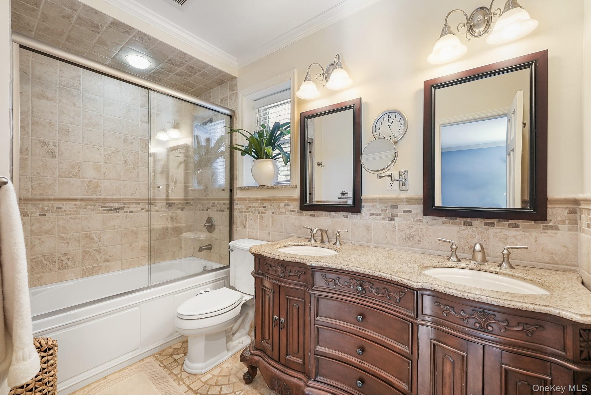 100 Yale Road Hartsdale, NY 10530 - Photo 29 of 42 a bathroom with a granite countertop sink mirror vanity bathtub and toilet
