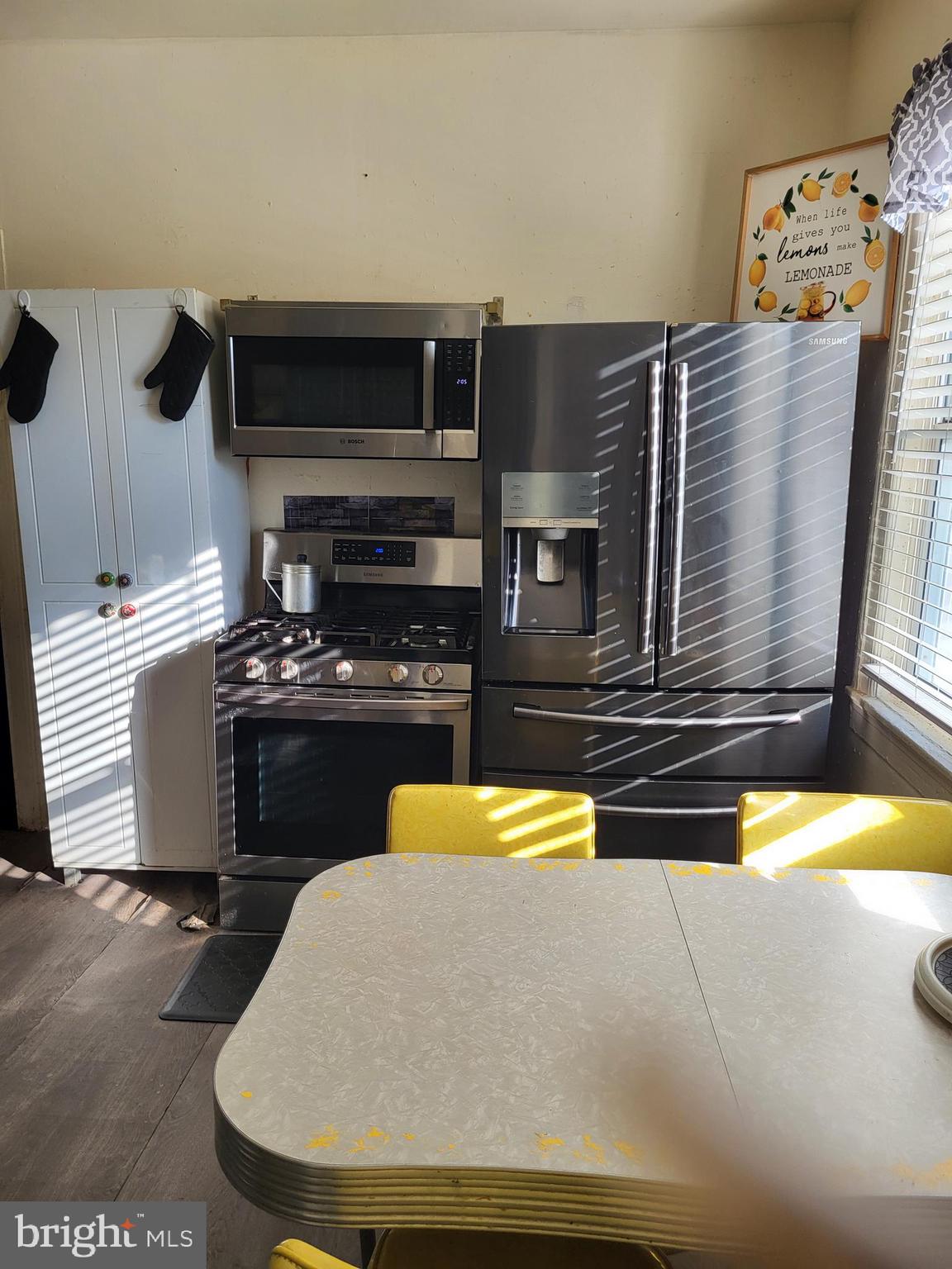 2806 Chelsea Terrace Baltimore, MD 21216 - Photo 12 of 36 a kitchen with a refrigerator and a stove