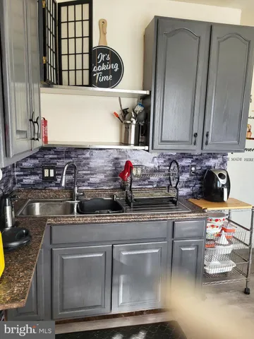 a kitchen with stainless steel appliances granite countertop a sink and a stove