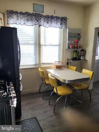 a view of a dining room with furniture and window