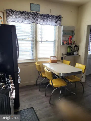 a view of a dining room with furniture and window
