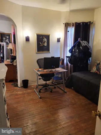 a living room with furniture and a air conditioner vent