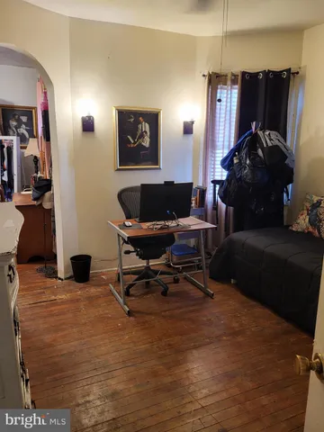 a living room with furniture and a air conditioner vent