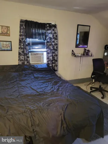 a bed sitting in a room next to a window